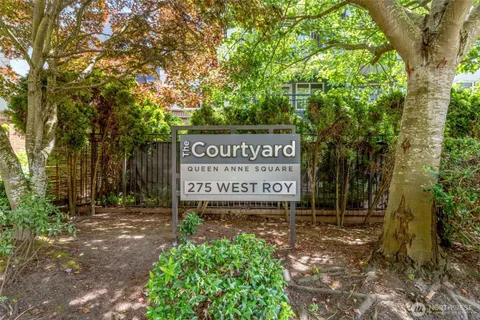a living room with furniture and floor to ceiling windows