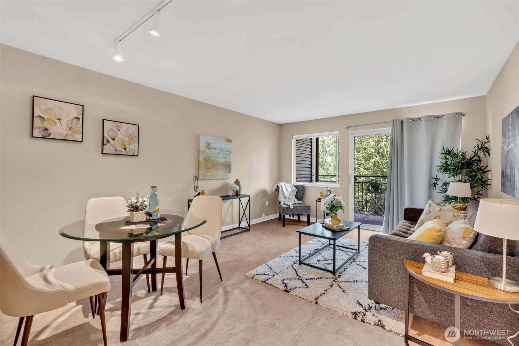 275 West Roy Street, Unit 319 Seattle, WA 98119 - Photo 5 of 30 a living room with furniture and floor to ceiling windows
