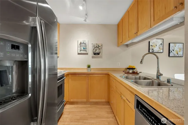 a kitchen with a sink and a refrigerator