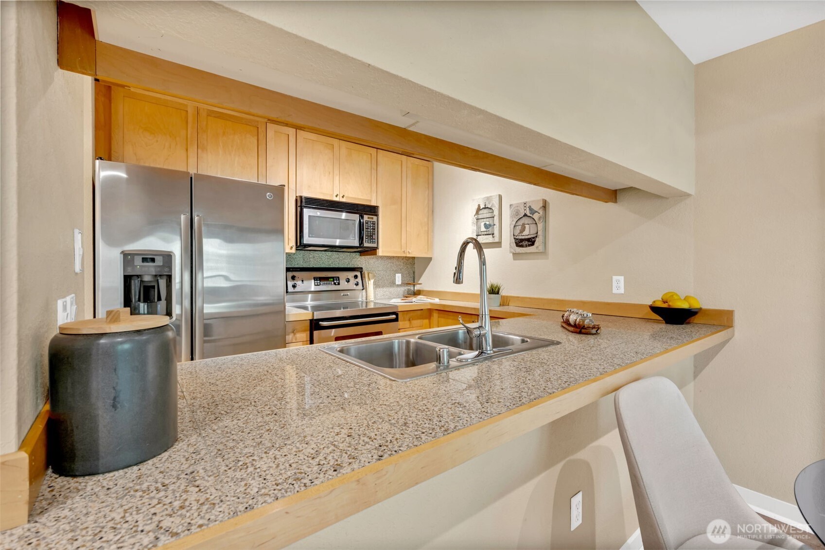 275 West Roy Street, Unit 319 Seattle, WA 98119 - Photo 10 of 30 a kitchen with a sink and a refrigerator