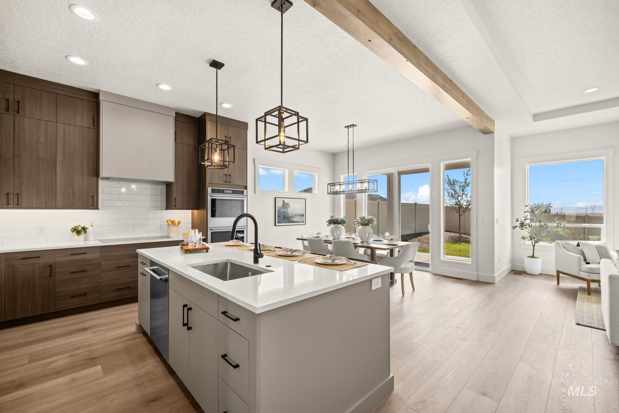 345 South Strut Way Boise, ID 83716 - Photo 5 of 50 Gourmet kitchen with stainless steel appliances, wood-finish flooring, and white quartz countertops