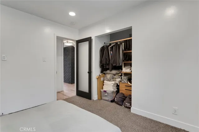 a view of an empty room with a fireplace and a window