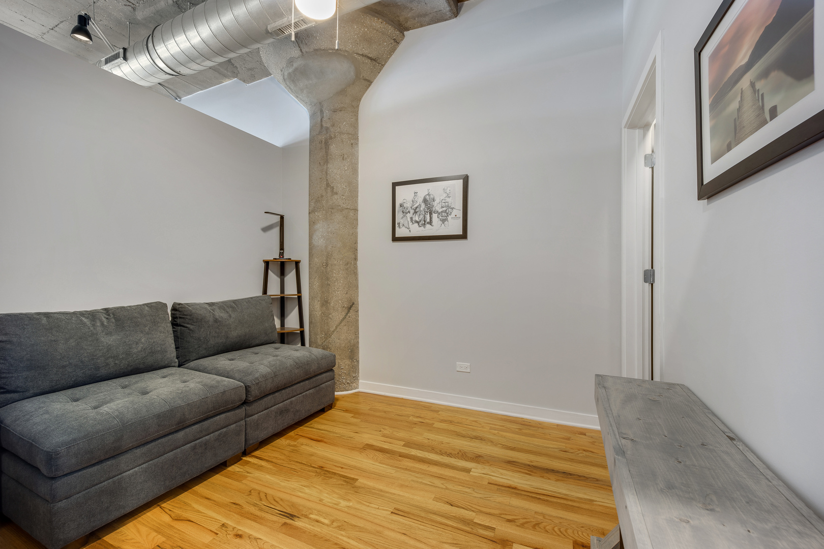 1111 West 15th Street, Unit 123 Chicago, IL 60608 - Photo 12 of 24 a living room with furniture and a wooden floor