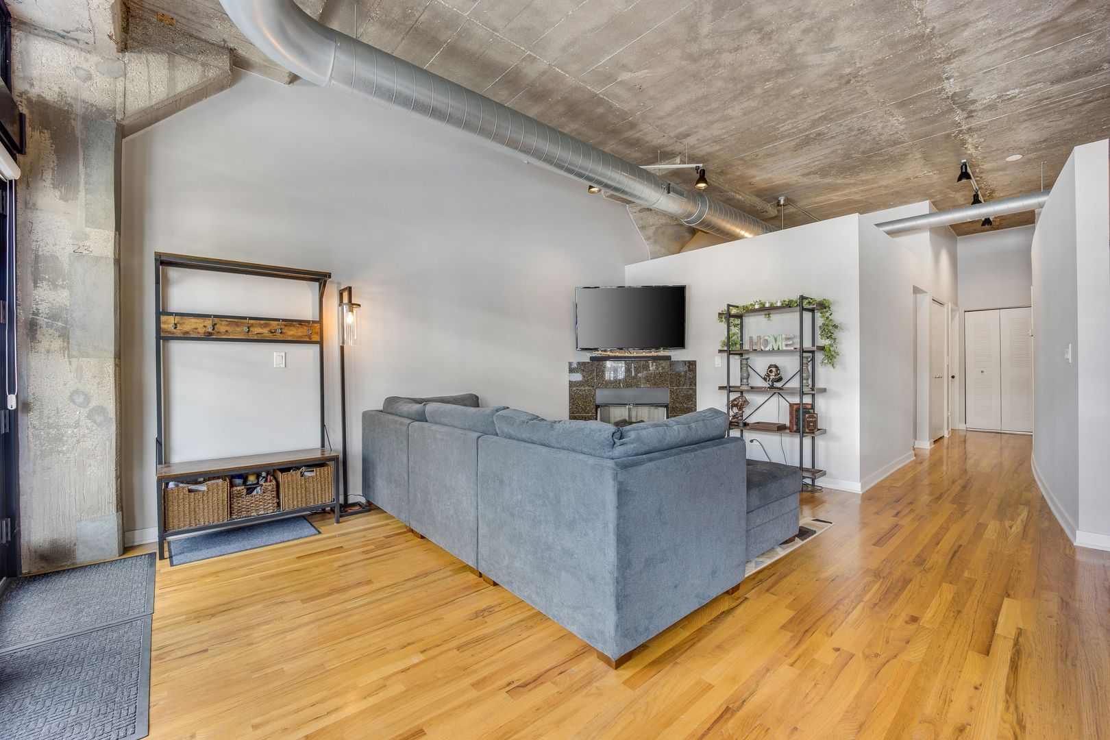 1111 West 15th Street, Unit 123 Chicago, IL 60608 - Photo 6 of 24 a living room with furniture and a flat screen tv