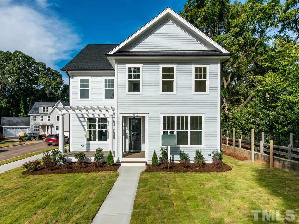 102 Revival Way Raleigh, NC 27608 - Photo 2 of 25 a front view of a house with a yard table and chairs