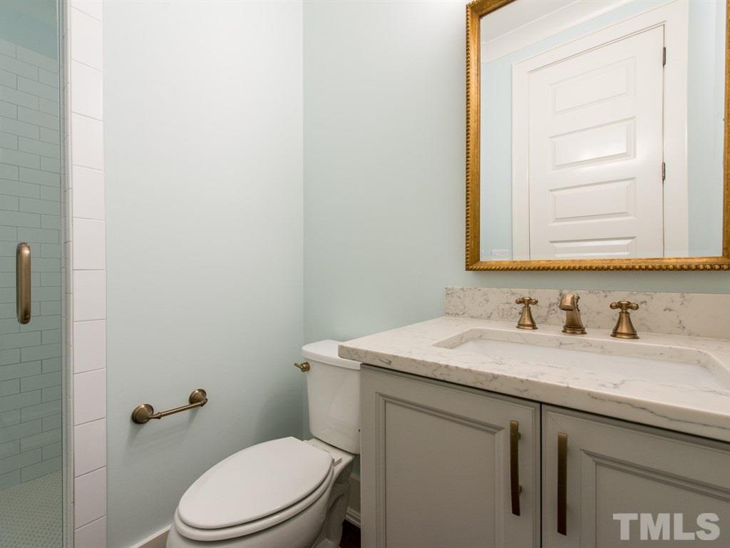 102 Revival Way Raleigh, NC 27608 - Photo 14 of 25 a bathroom with a granite countertop sink toilet and mirror
