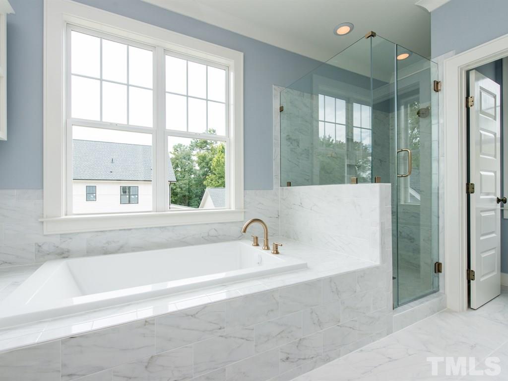 102 Revival Way Raleigh, NC 27608 - Photo 17 of 25 a bathroom with a bathtub and a shower