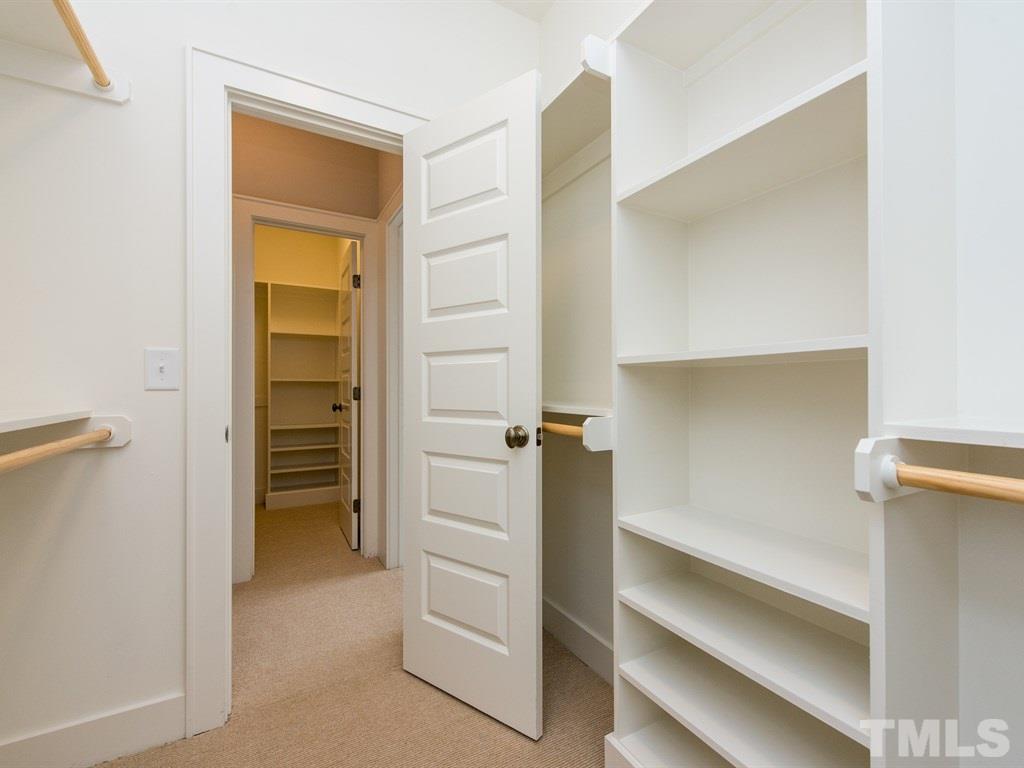 102 Revival Way Raleigh, NC 27608 - Photo 18 of 25 a view of walk in closet with empty racks