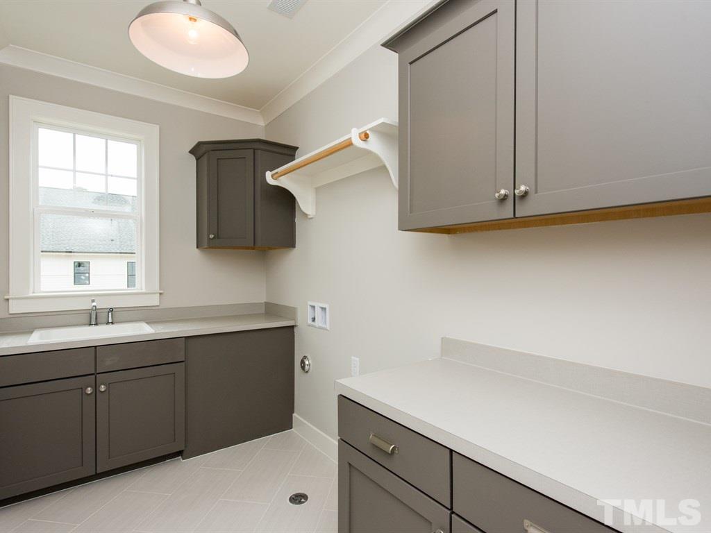 102 Revival Way Raleigh, NC 27608 - Photo 21 of 25 a kitchen with a sink and cabinets