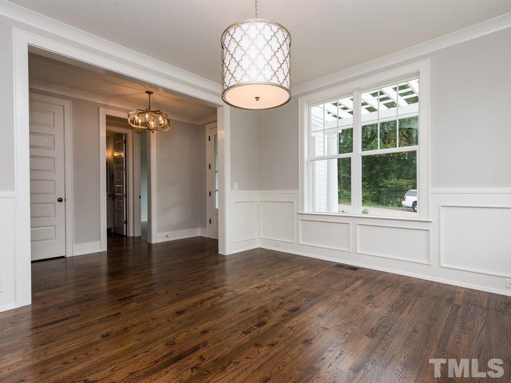 102 Revival Way Raleigh, NC 27608 - Photo 4 of 25 an empty room with wooden floor chandelier and windows