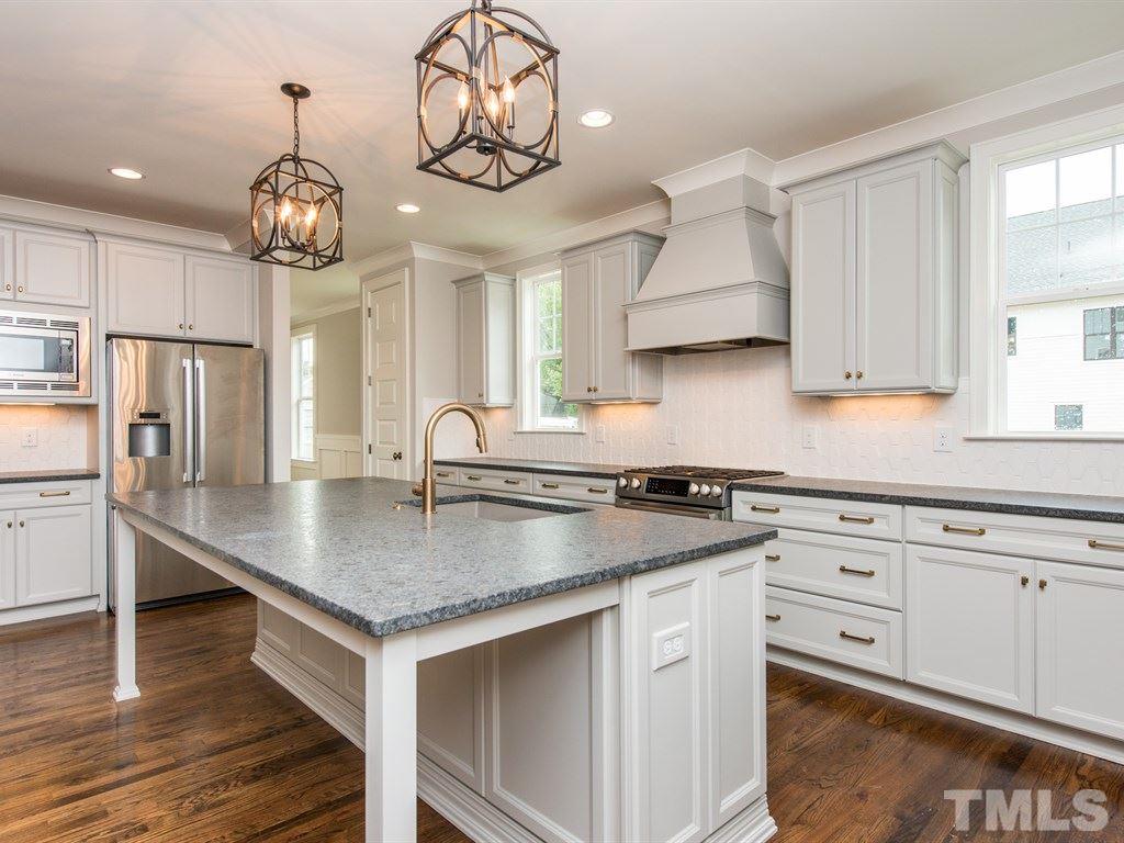 102 Revival Way Raleigh, NC 27608 - Photo 6 of 25 a kitchen with stainless steel appliances granite countertop a sink a stove and a wooden floors