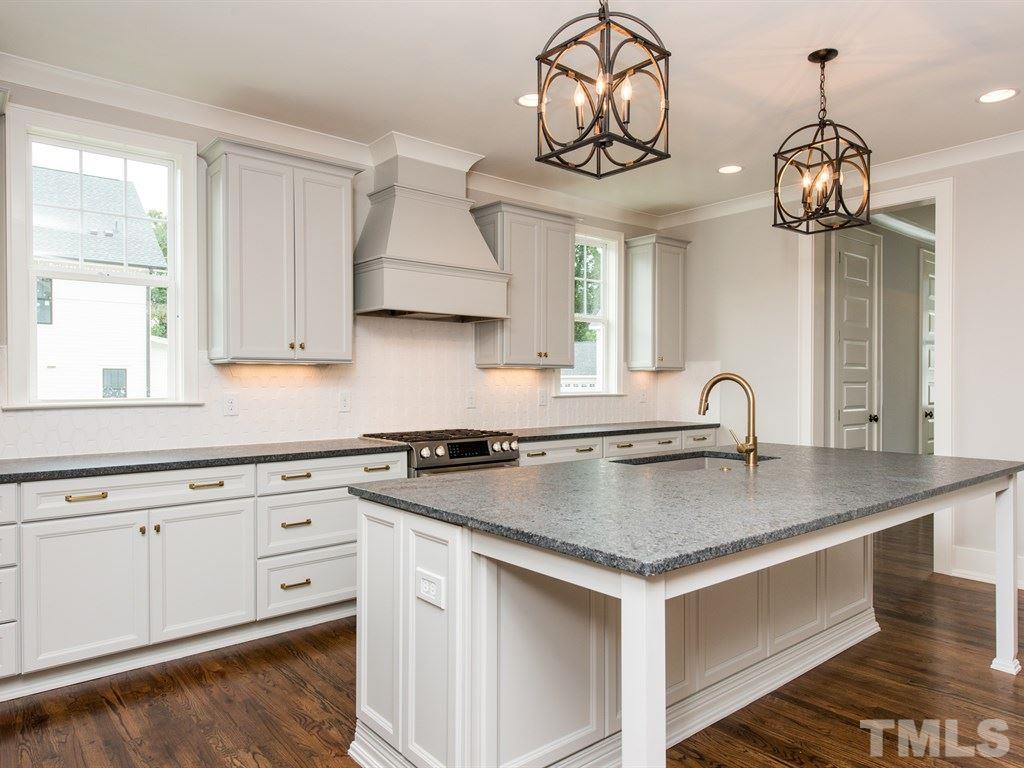 102 Revival Way Raleigh, NC 27608 - Photo 8 of 25 a kitchen with stainless steel appliances granite countertop a sink a stove and a window