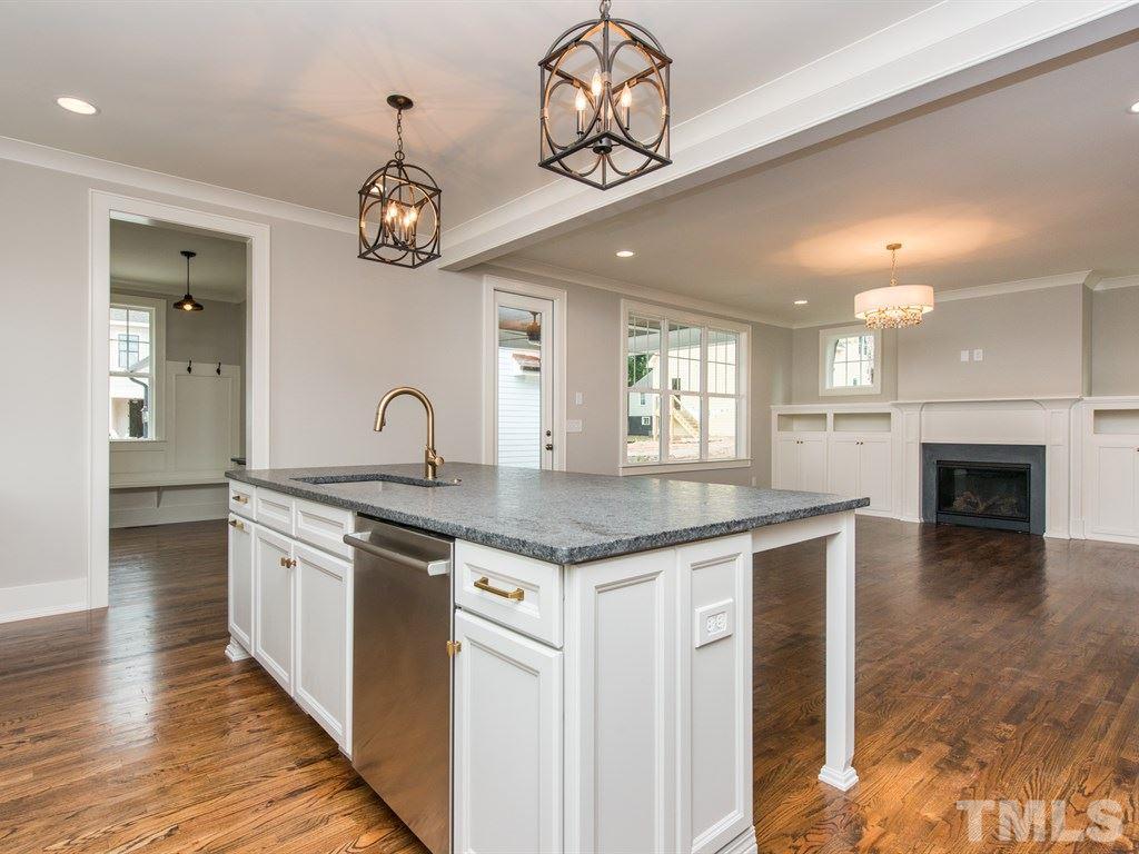 102 Revival Way Raleigh, NC 27608 - Photo 10 of 25 an open kitchen with a stove and a wooden floors