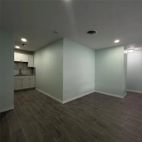 an empty room with a kitchen