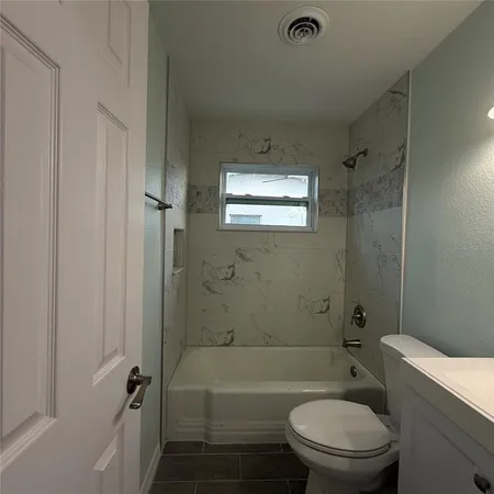 a bathroom with a toilet a sink and bathtub