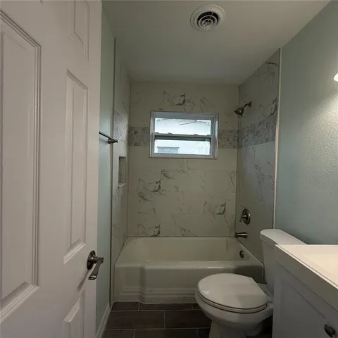 a bathroom with a toilet a sink and bathtub