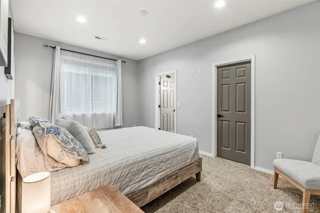 a bedroom with a bed and a lamp