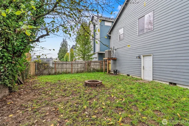 a view of a backyard with large tree