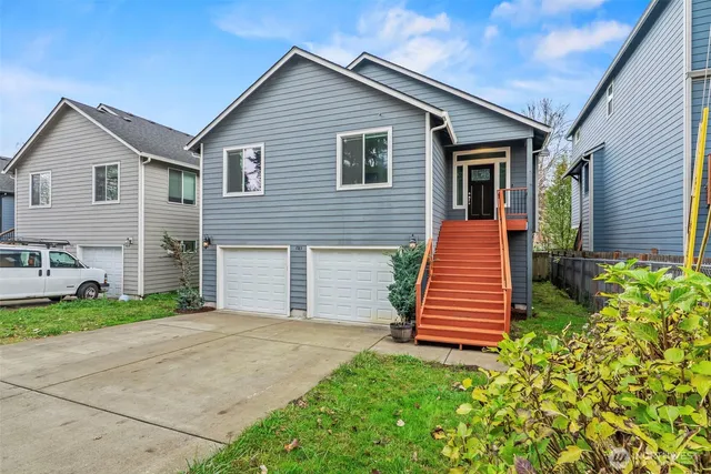 a front view of a house with a garden