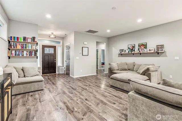 a living room with furniture and kitchen view