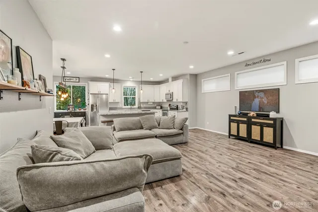 a living room with furniture and view of kitchen