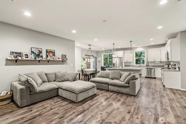 a kitchen with kitchen island granite countertop lots of counter top space and stainless steel appliances