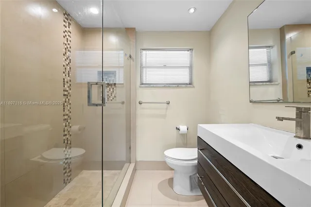 a bathroom with a toilet sink and shower
