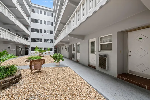 a view of a patio with a table and chairs