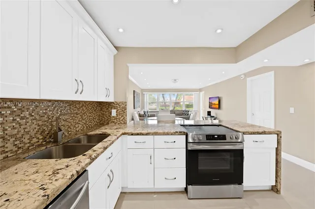 a kitchen with a stove sink and cabinets