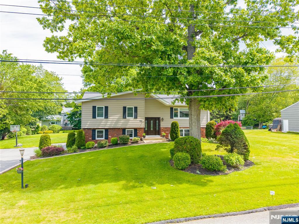 55 Marcia Road Ringwood, NJ 07456 - Photo 1 of 42 a view of a house with a backyard patio and sitting area