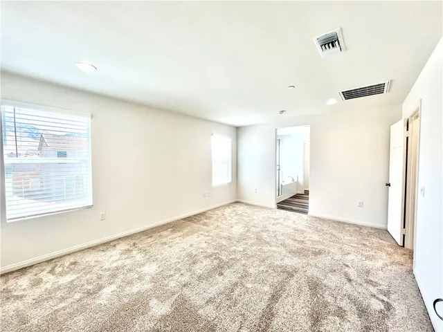 a spacious bathroom with a tub shower and mirror