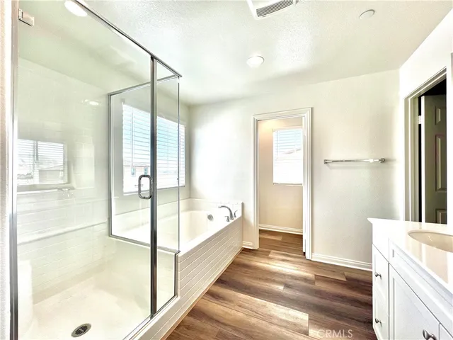 a spacious bathroom with a granite countertop sink and a mirror