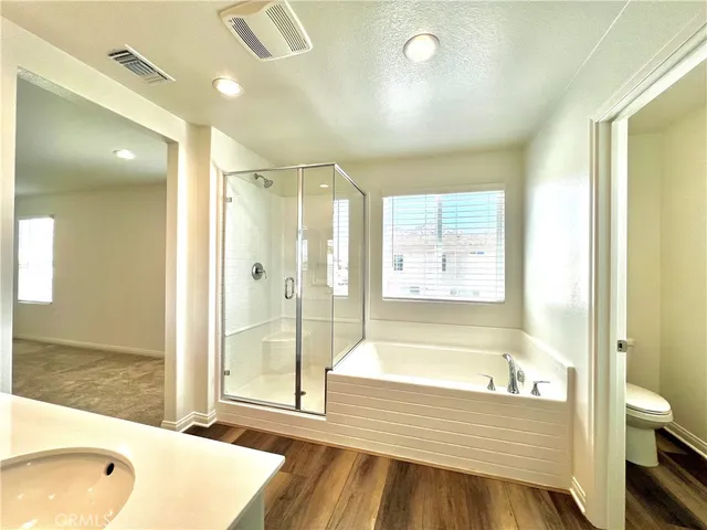 a white toilet sitting next to a window