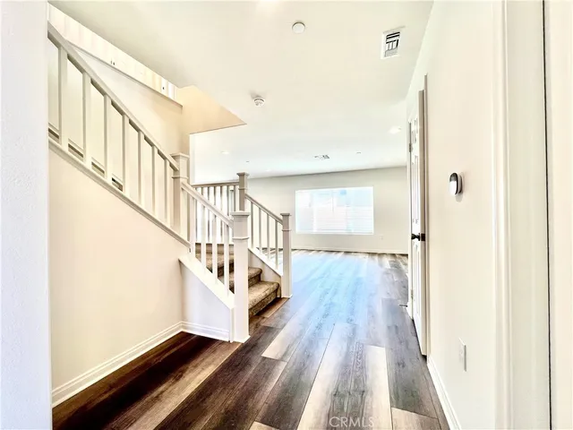 a view of an entryway with wooden floor