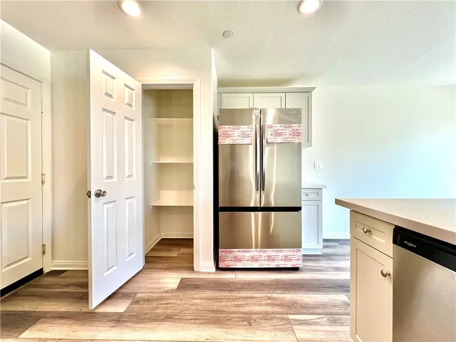 a view of a kitchen with a sink and a refrigerator