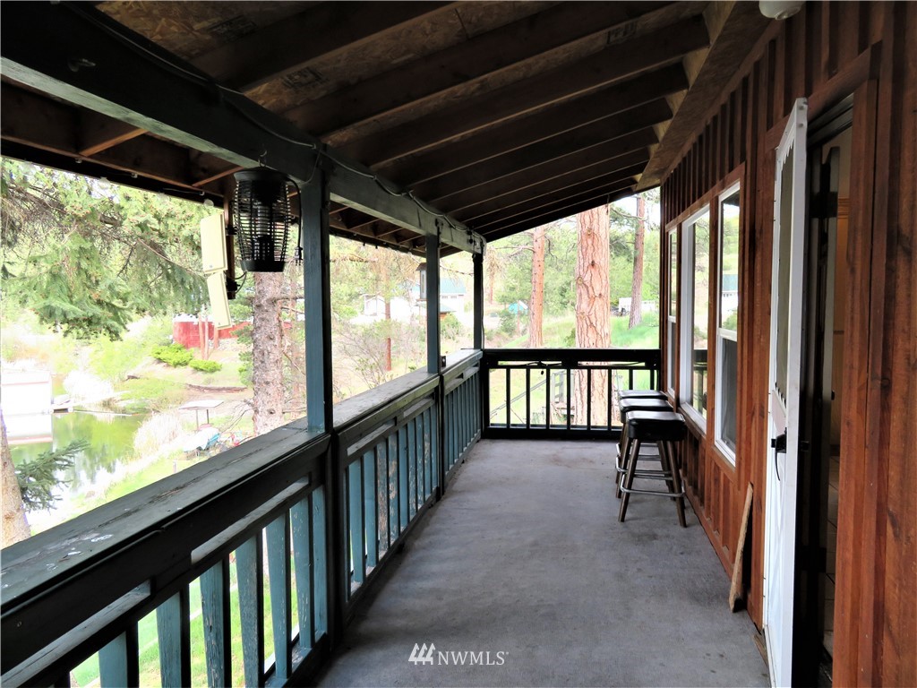58 Petes Retreat Road Republic, WA 99166 - Photo 14 of 32 a view of a porch with wooden floor and outdoor space