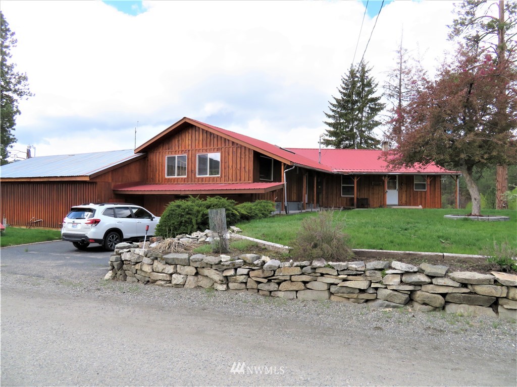 58 Petes Retreat Road Republic, WA 99166 - Photo 31 of 32 a front view of a house with a yard and garage