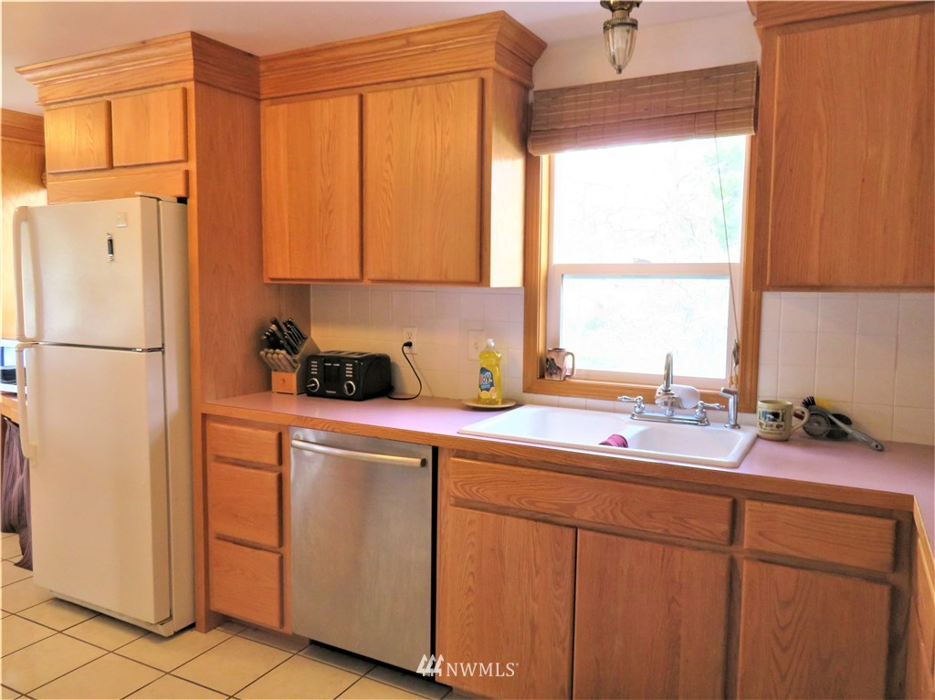 58 Petes Retreat Road Republic, WA 99166 - Photo 7 of 32 a kitchen with a refrigerator and a sink