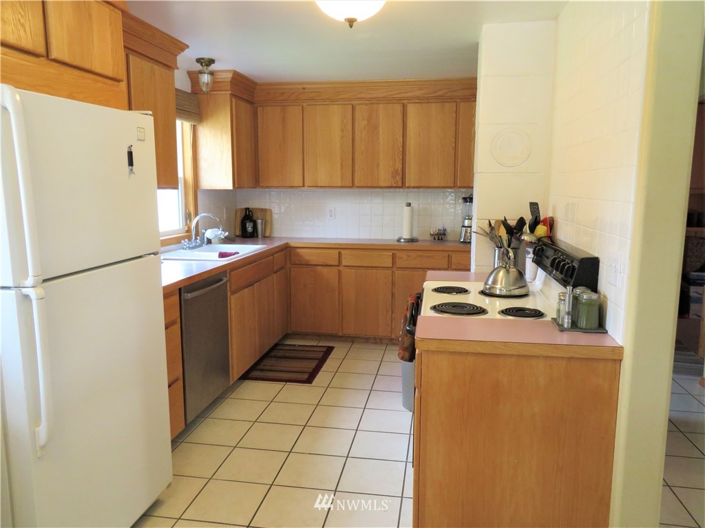 58 Petes Retreat Road Republic, WA 99166 - Photo 8 of 32 a kitchen with a refrigerator sink stove and cabinets