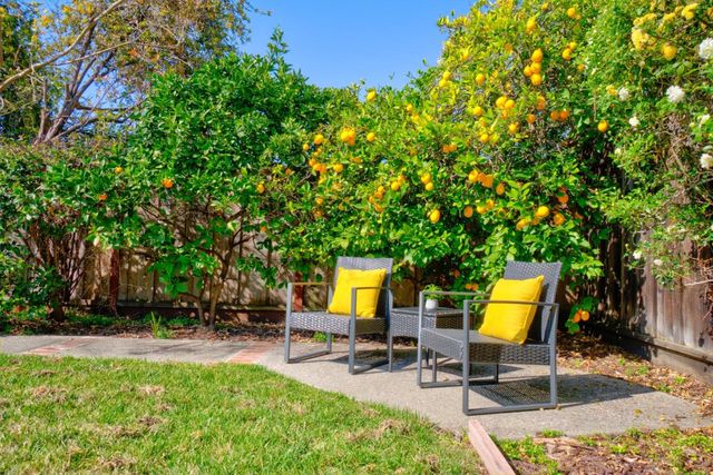 a view of a backyard with sitting area
