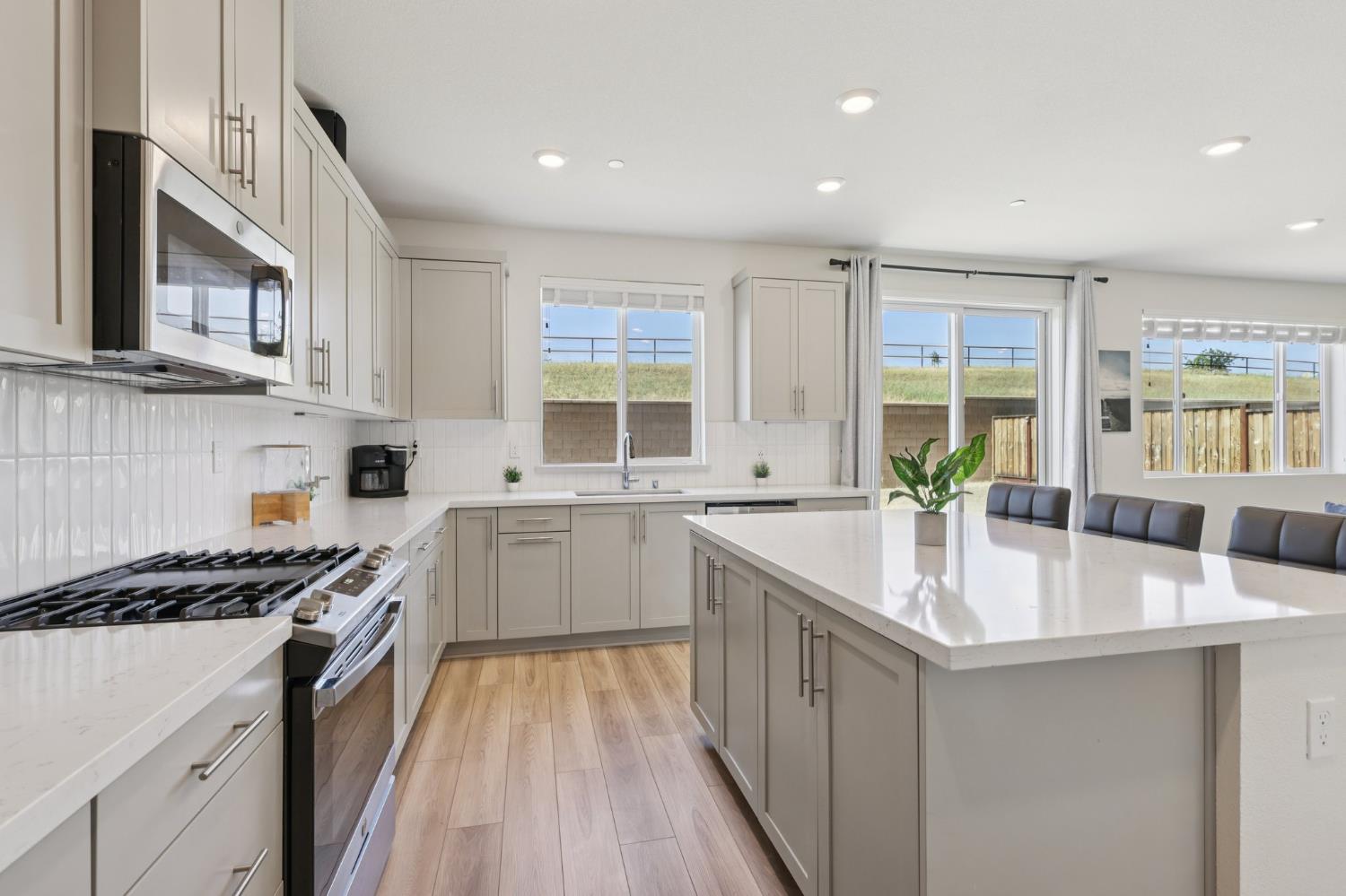 3946 Needham Street Tracy, CA 95377 - Photo 11 of 40 a kitchen with granite countertop a sink stove and cabinets