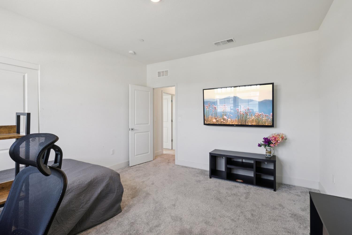 3946 Needham Street Tracy, CA 95377 - Photo 20 of 40 a bedroom with furniture and a couch