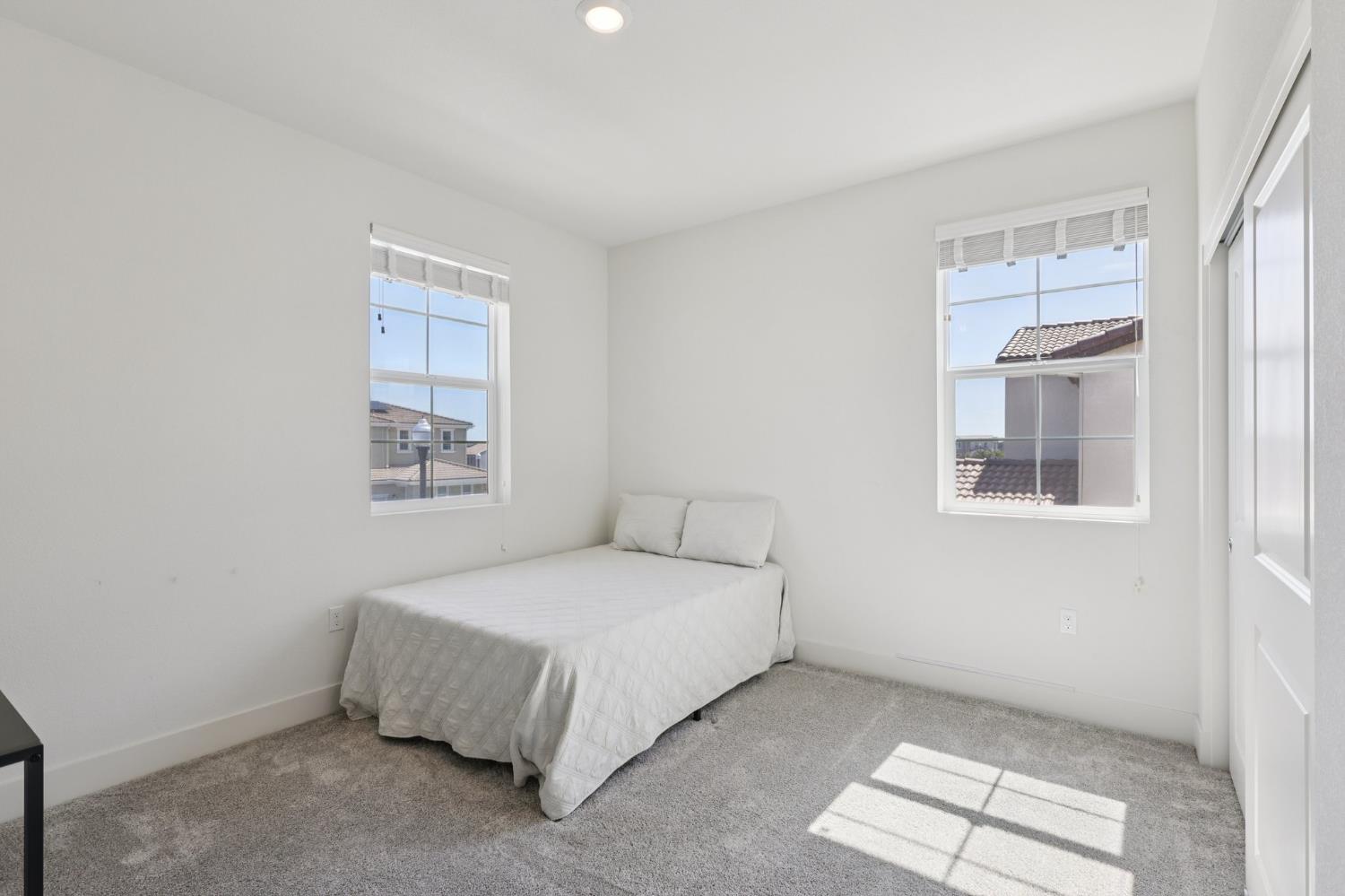 3946 Needham Street Tracy, CA 95377 - Photo 21 of 40 a bedroom with a bed and a window