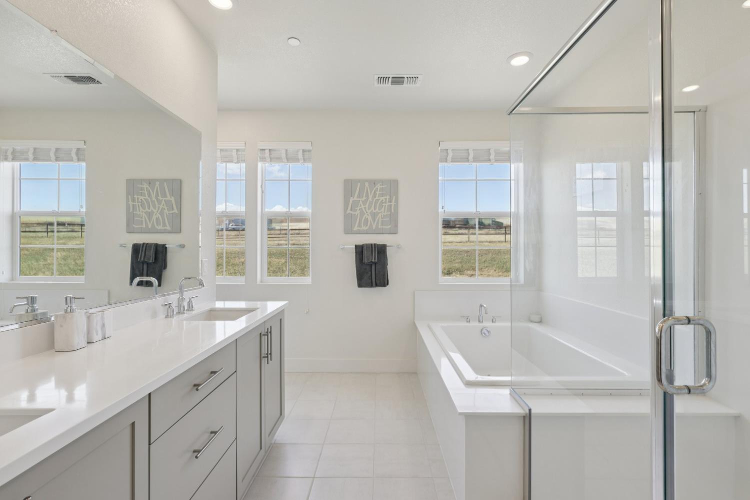 3946 Needham Street Tracy, CA 95377 - Photo 26 of 40 a bathroom with a sink double vanity and a tub