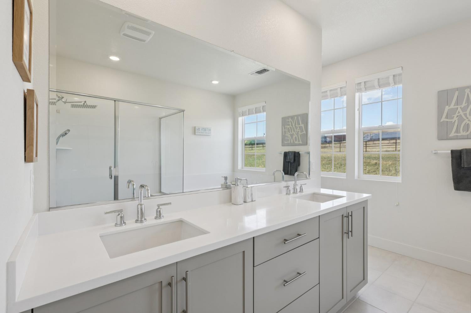 3946 Needham Street Tracy, CA 95377 - Photo 29 of 40 a bathroom with double sink and a mirror