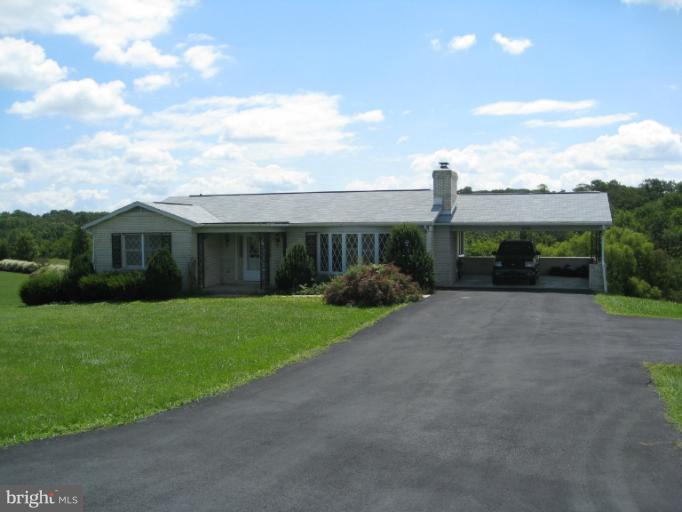 4599 Griffith Road Mount Airy, MD 21771 - Photo 6 of 11 a front view of a house with a yard and garage