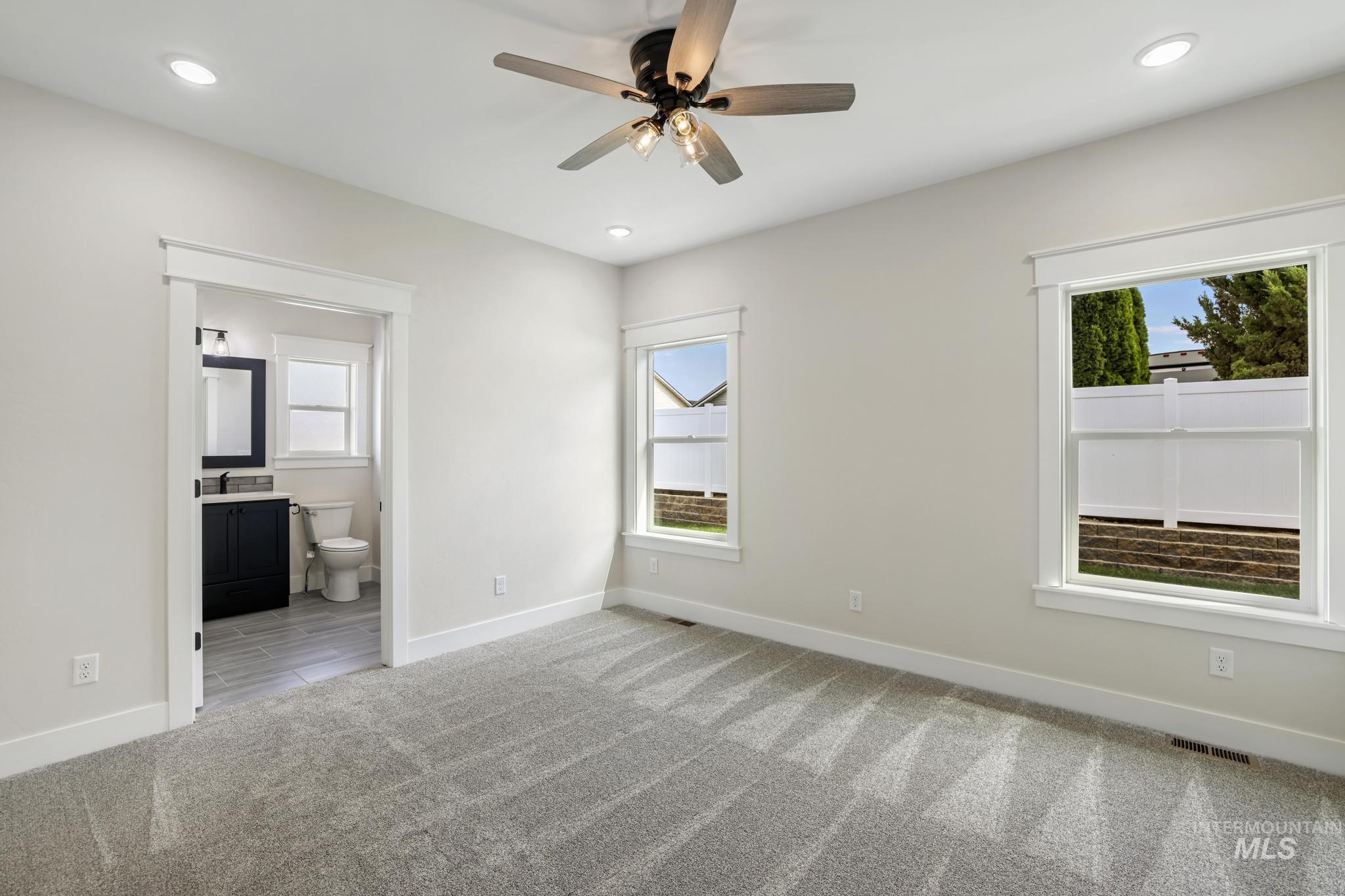1441 Haizlee Way Twin Falls, ID 83301 - Photo 11 of 26 Unfurnished bedroom with ceiling fan, light colored carpet, recessed lighting, and ensuite bath