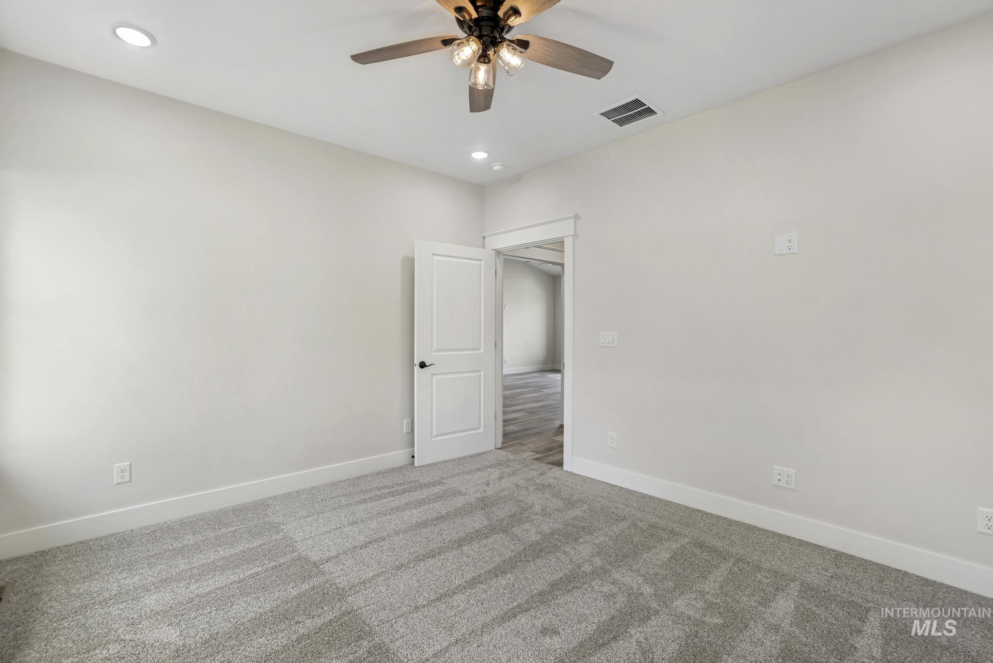 1441 Haizlee Way Twin Falls, ID 83301 - Photo 12 of 26 Unfurnished bedroom with carpet, ceiling fan, and recessed lighting