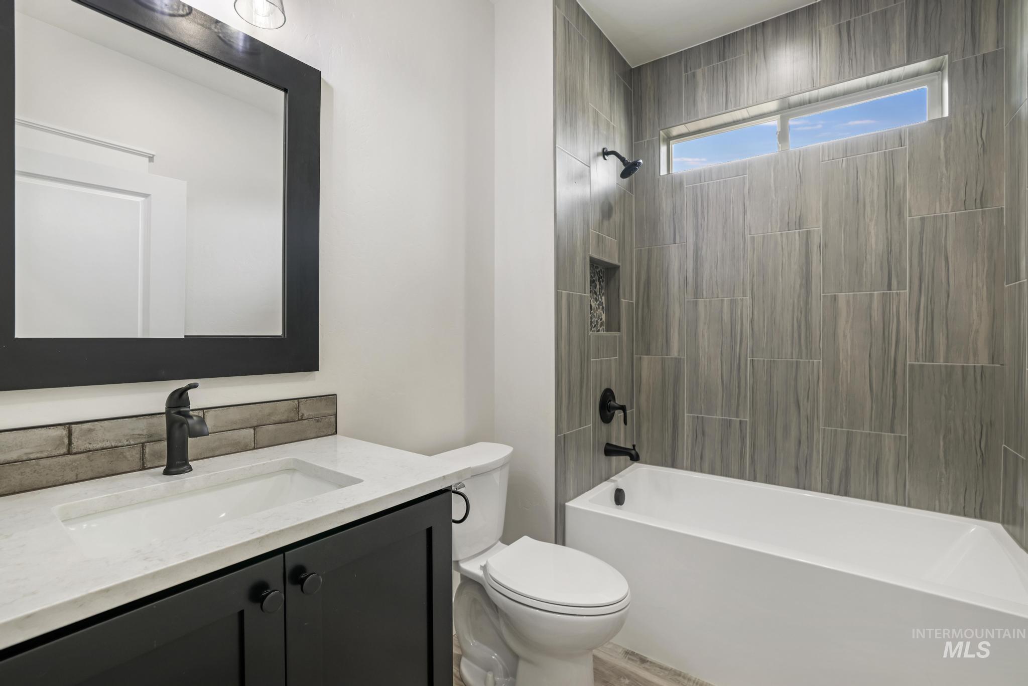 1441 Haizlee Way Twin Falls, ID 83301 - Photo 16 of 26 Full bathroom featuring vanity, shower / bath combination, and light wood-style floors