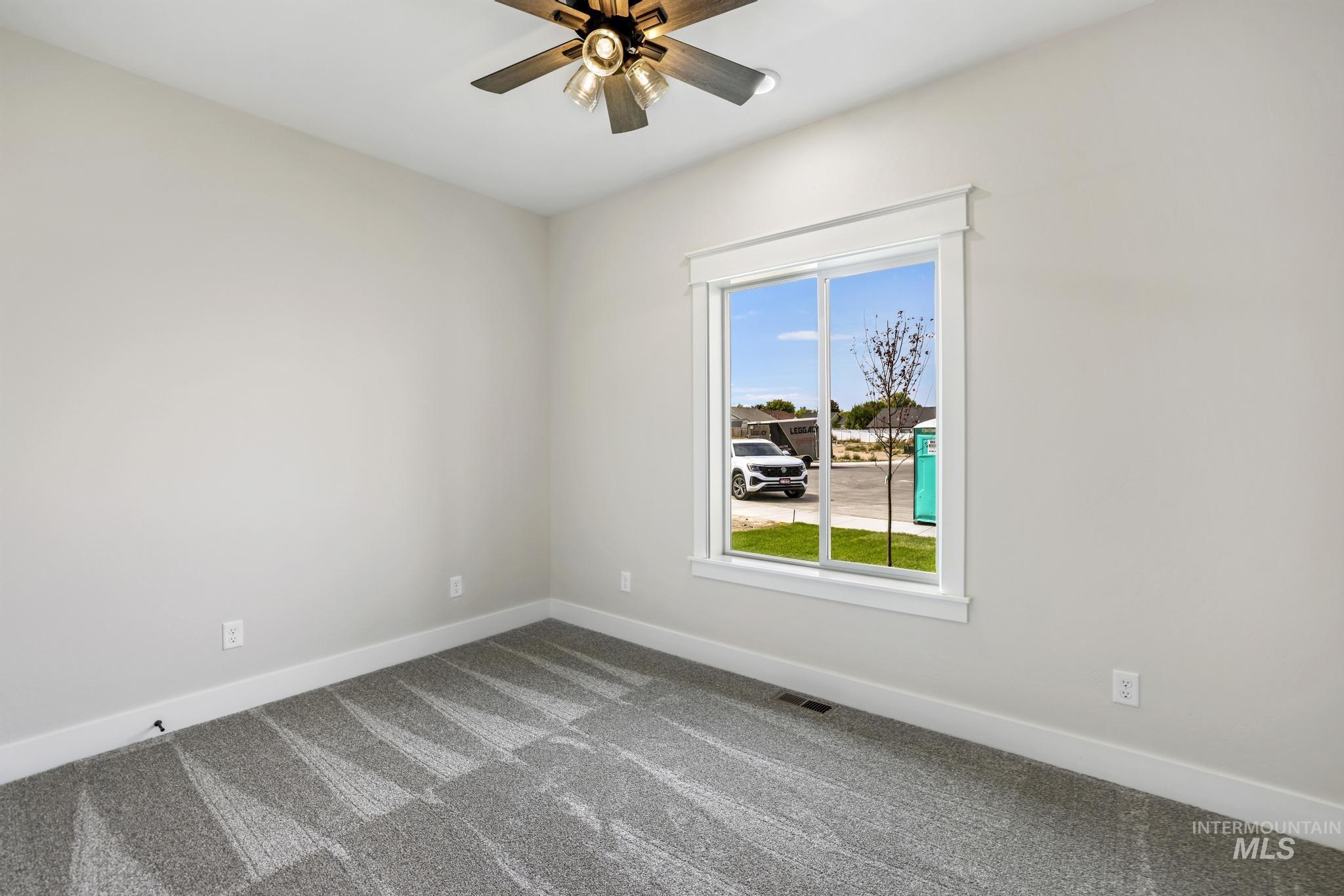1441 Haizlee Way Twin Falls, ID 83301 - Photo 17 of 26 Unfurnished room with ceiling fan and light colored carpet
